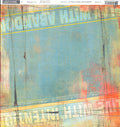 Live Play 12x12 cardstock by BasicGrey Aged and Confused Sublime Collection, featuring a bold mixed-media collage with teal blue-grey color block center coral orange and golden yellow edges bold white typography reading Play With Abandon and At Full Tilt cursive script yellow stripe and black grid lines
