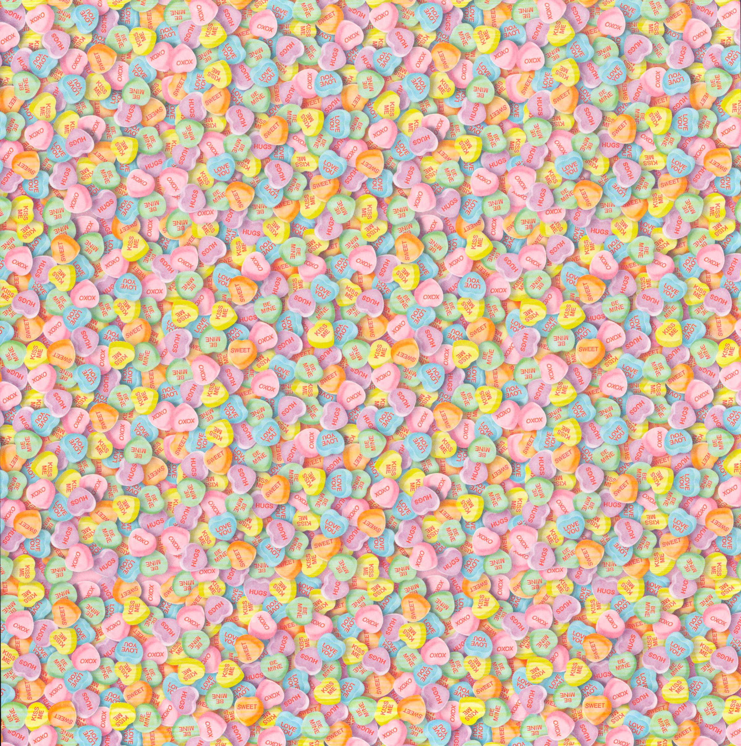 The Paper Studio Candy Hearts 12x12 scrapbook paper - edge-to-edge photorealistic pastel candy conversation hearts in pink, blue, yellow, orange, lavender, and mint with XOXO, Hugs, Kiss Me, Be Mine messages